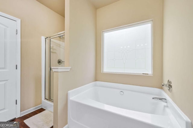 2939 Woodward Down Trl, Buford, GA 30519 - bathroom with a bath, a shower stall, and wood finished floors