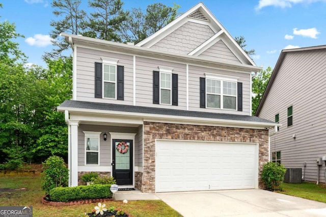 2939 Woodward Down Trl, Buford, GA 30519 - craftsman inspired home with stone siding, central AC unit, a garage, and driveway