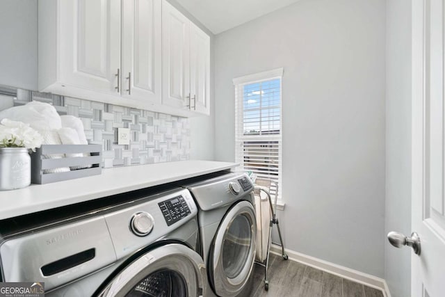 2939 Woodward Down Trl, Buford, GA 30519 - laundry room with separate washer and dryer, cabinet space, wood finished floors, and baseboards
