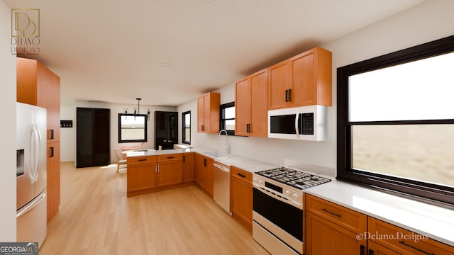 458 Shannon Dr SW, Atlanta, GA 30310 - kitchen with stainless steel appliances, a peninsula, a sink, light wood-type flooring, and light countertops