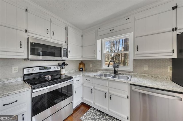 3271 Sutcliffe Rdg, Marietta, GA 30064 - kitchen with appliances with stainless steel finishes, a sink, white cabinetry, a textured ceiling, and ornamental molding