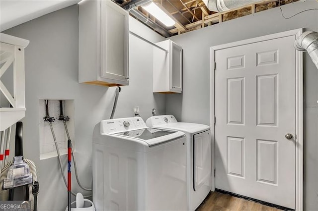 3271 Sutcliffe Rdg, Marietta, GA 30064 - laundry room with cabinet space, washer and clothes dryer, and wood finished floors