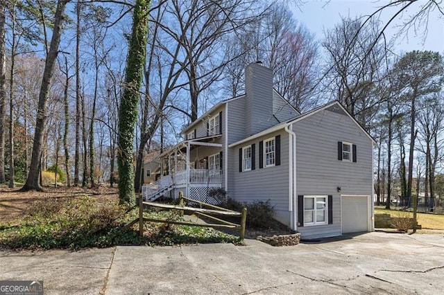 3271 Sutcliffe Rdg, Marietta, GA 30064 - view of property exterior with driveway, a garage, a chimney, a porch, and stairs
