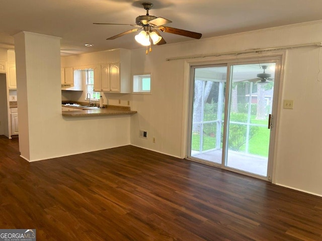 988 Hickory Ridge Dr, Macon, GA 31204 - kitchen with white cabinets, dark wood-style flooring, a ceiling fan, a sink, and baseboards