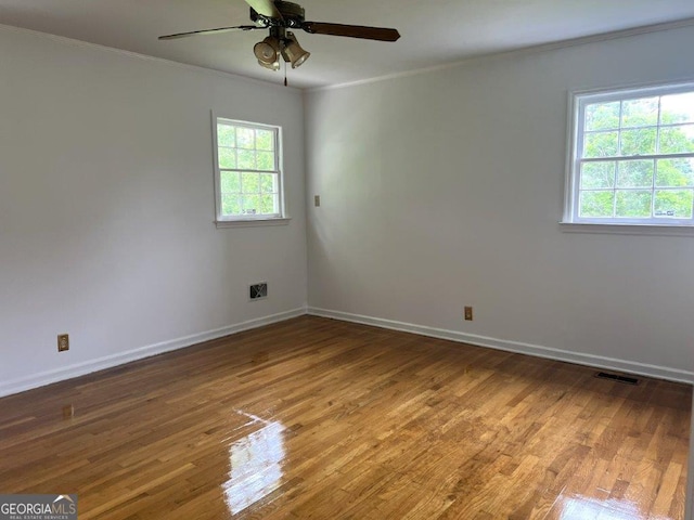 988 Hickory Ridge Dr, Macon, GA 31204 - spare room with healthy amount of natural light, crown molding, wood finished floors, a ceiling fan, and baseboards