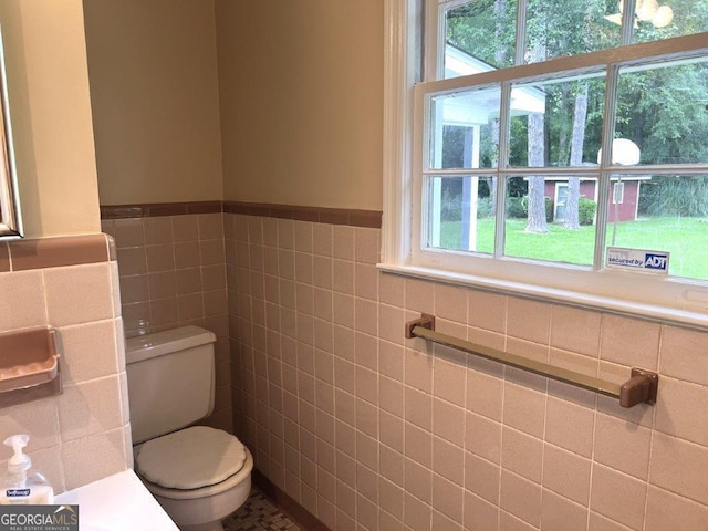 988 Hickory Ridge Dr, Macon, GA 31204 - bathroom with tile walls, toilet, and a wainscoted wall