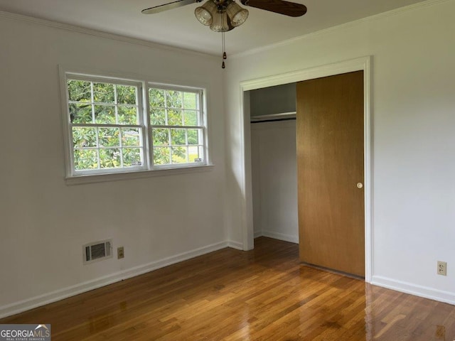 988 Hickory Ridge Dr, Macon, GA 31204 - unfurnished bedroom with wood finished floors, crown molding, a closet, baseboards, and a ceiling fan