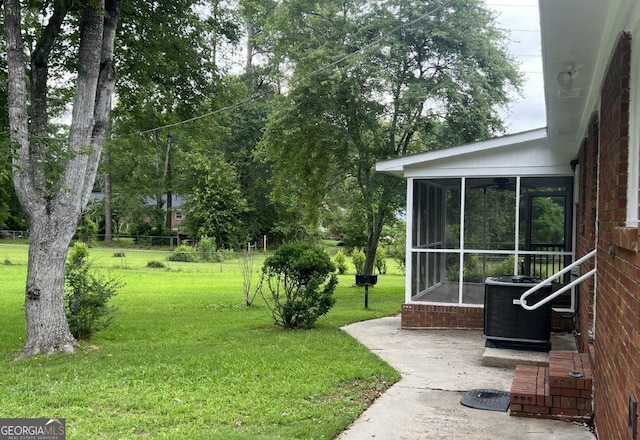 988 Hickory Ridge Dr, Macon, GA 31204 - view of green lawn with central AC and a sunroom