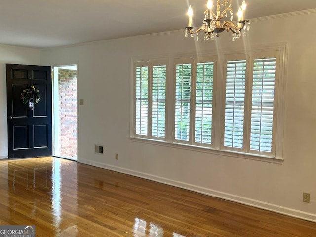 988 Hickory Ridge Dr, Macon, GA 31204 - entryway featuring baseboards, wood finished floors, a chandelier, and ornamental molding