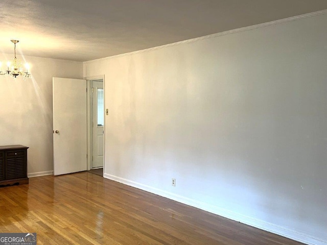 988 Hickory Ridge Dr, Macon, GA 31204 - empty room featuring a chandelier, wood finished floors, baseboards, and ornamental molding
