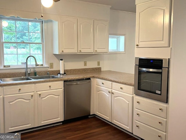 988 Hickory Ridge Dr, Macon, GA 31204 - kitchen with stainless steel appliances, a sink, white cabinetry, crown molding, and dark wood finished floors