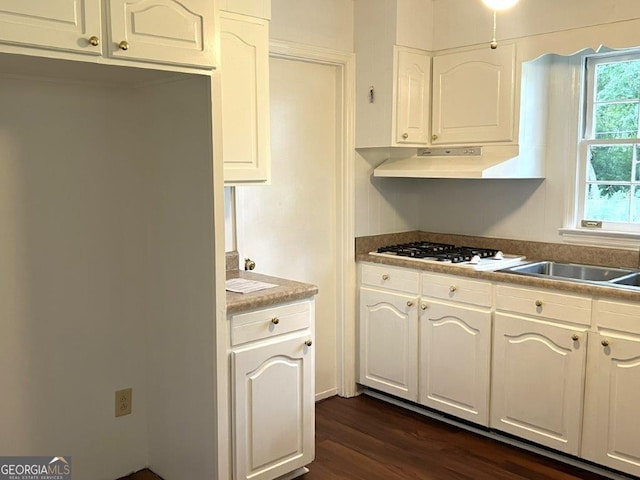 988 Hickory Ridge Dr, Macon, GA 31204 - kitchen with white gas cooktop, dark wood finished floors, white cabinets, and a sink