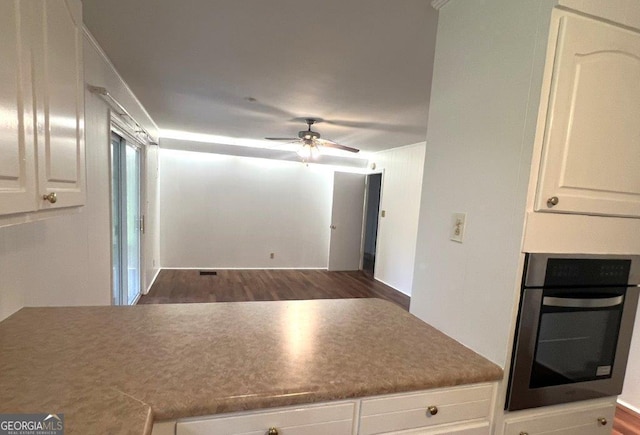 988 Hickory Ridge Dr, Macon, GA 31204 - kitchen with stainless steel oven, ceiling fan, wood finished floors, and white cabinets