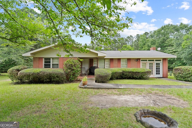 114 Pippin Rd, Hillsboro, GA 31038 - single story home featuring brick siding, a front yard, and a chimney