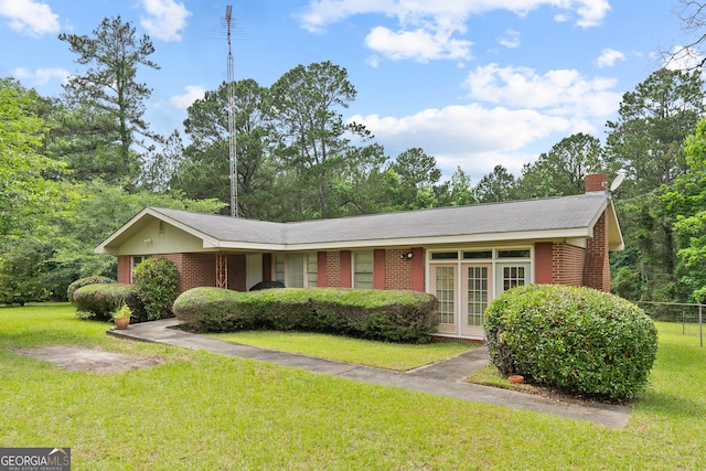 114 Pippin Rd, Hillsboro, GA 31038 - ranch-style house with brick siding and a chimney