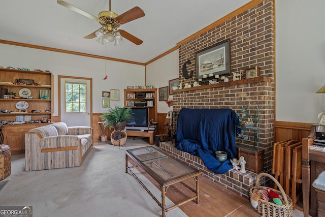 114 Pippin Rd, Hillsboro, GA 31038 - carpeted living room featuring wainscoting, a ceiling fan, crown molding, a brick fireplace, and wood walls