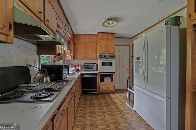 114 Pippin Rd, Hillsboro, GA 31038 - kitchen with black appliances, wallpapered walls, brown cabinets, under cabinet range hood, and light countertops