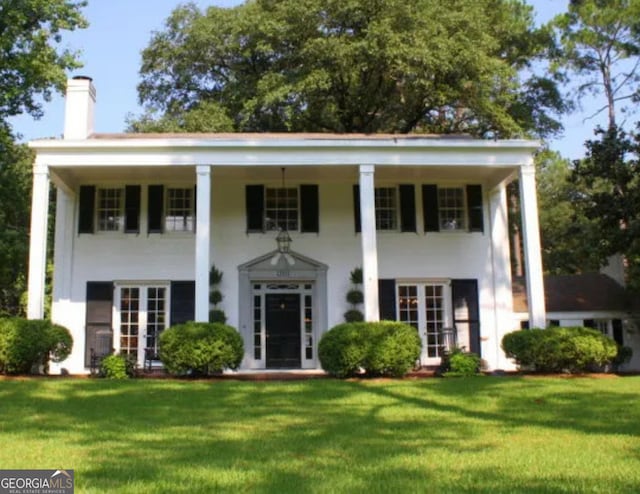 1201 Rawson Dr, Albany, GA 31701 - greek revival inspired property with a front lawn, a chimney, and stucco siding