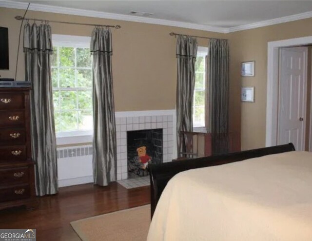 1201 Rawson Dr, Albany, GA 31701 - bedroom with wood finished floors, ornamental molding, and a fireplace