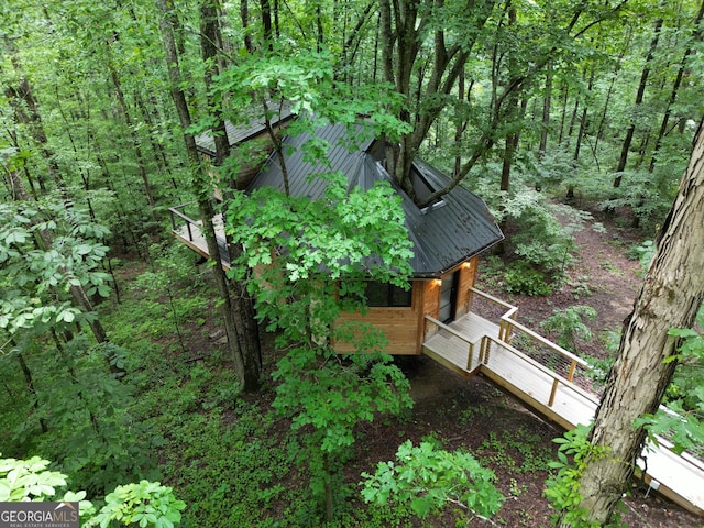 6290 Cascade Palmetto Hwy, Fairburn, GA 30213 - view of side of home featuring metal roof, a wooden deck, and a wooded view