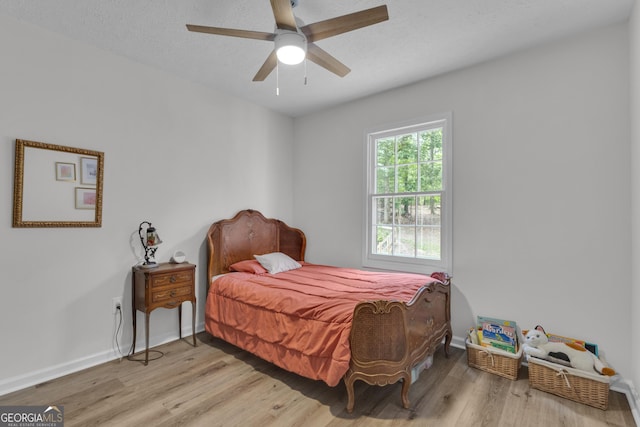 6290 Cascade Palmetto Hwy, Fairburn, GA 30213 - bedroom with wood finished floors, baseboards, and ceiling fan