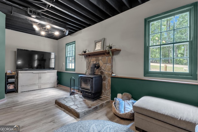 6290 Cascade Palmetto Hwy, Fairburn, GA 30213 - living area with a wood stove, wood finished floors, and baseboards