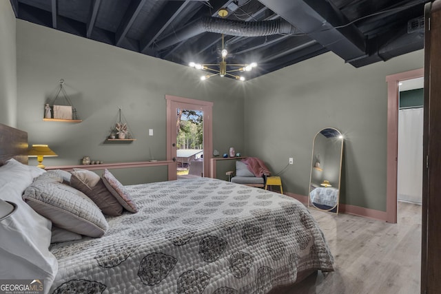 6290 Cascade Palmetto Hwy, Fairburn, GA 30213 - bedroom with wood finished floors, a chandelier, and baseboards