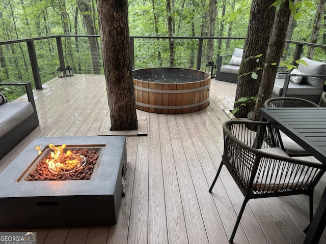 6290 Cascade Palmetto Hwy, Fairburn, GA 30213 - wooden deck featuring a fire pit, an outdoor hot tub, and a wooded view