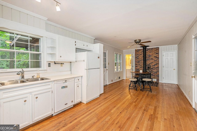 3431 Alcan Way, Tucker, GA 30084 - kitchen featuring white appliances, a sink, a wood stove, crown molding, and open shelves