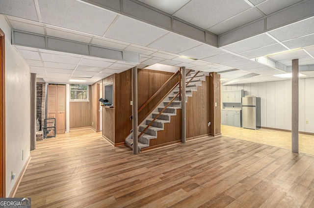 3431 Alcan Way, Tucker, GA 30084 - basement with freestanding refrigerator, wood finished floors, stairway, baseboards, and a drop ceiling