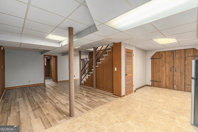 3431 Alcan Way, Tucker, GA 30084 - finished basement with a drop ceiling, stairway, wood finished floors, freestanding refrigerator, and baseboards