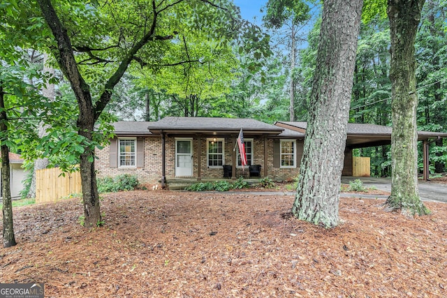 3431 Alcan Way, Tucker, GA 30084 - ranch-style home with brick siding, an attached carport, a porch, and roof with shingles