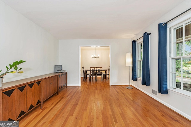 3431 Alcan Way, Tucker, GA 30084 - unfurnished room with light wood-style flooring, baseboards, and a chandelier