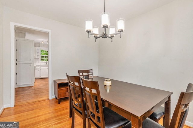 3431 Alcan Way, Tucker, GA 30084 - dining room with light wood-style flooring, a chandelier, and baseboards