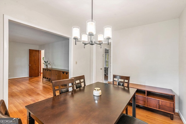 3431 Alcan Way, Tucker, GA 30084 - dining room with light wood-style floors, a chandelier, and baseboards