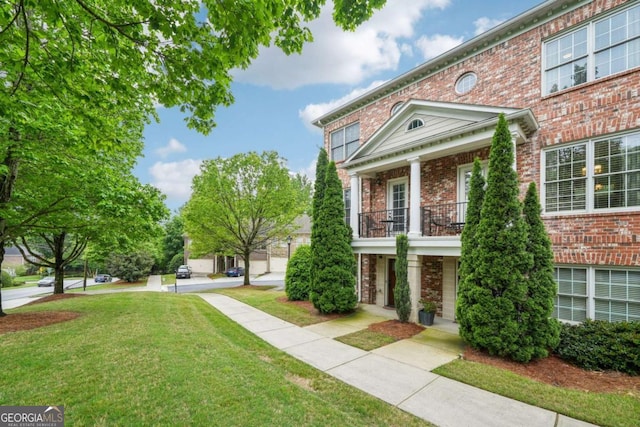 1858 Preserve Way, Atlanta, GA 30341 - view of front of property with brick siding, a balcony, and a front yard