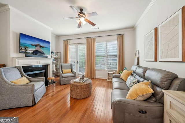 1858 Preserve Way, Atlanta, GA 30341 - living room featuring ornamental molding, light wood-style floors, a ceiling fan, a fireplace, and baseboards