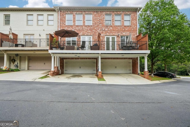 1858 Preserve Way, Atlanta, GA 30341 - townhome / multi-family property with an attached garage, brick siding, driveway, french doors, and a balcony