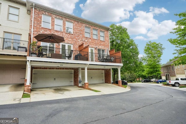 1858 Preserve Way, Atlanta, GA 30341 - view of front facade featuring brick siding, a garage, driveway, and a balcony