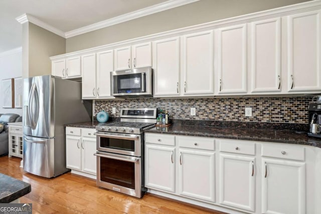 1858 Preserve Way, Atlanta, GA 30341 - kitchen with appliances with stainless steel finishes, crown molding, white cabinets, tasteful backsplash, and light wood-type flooring