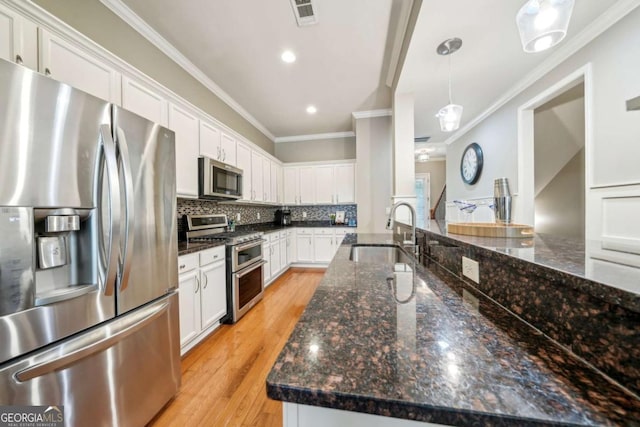 1858 Preserve Way, Atlanta, GA 30341 - kitchen featuring stainless steel appliances, a sink, white cabinetry, ornamental molding, and decorative backsplash