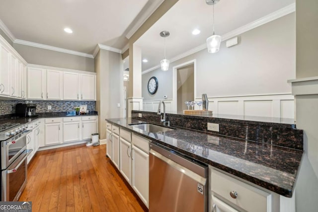 1858 Preserve Way, Atlanta, GA 30341 - kitchen with appliances with stainless steel finishes, a sink, ornamental molding, white cabinetry, and decorative light fixtures
