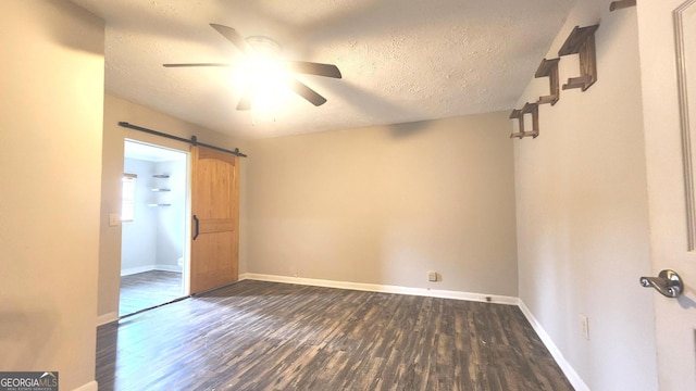 4326 Ga Highway 109, Molena, GA 30258 - unfurnished room with dark wood-style floors, a ceiling fan, a textured ceiling, a barn door, and baseboards