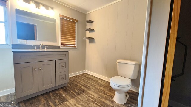 4326 Ga Highway 109, Molena, GA 30258 - bathroom with baseboards, wood finished floors, crown molding, toilet, and vanity