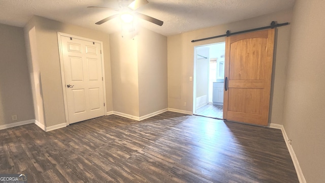 4326 Ga Highway 109, Molena, GA 30258 - unfurnished bedroom with dark wood-style flooring, a textured ceiling, baseboards, and a ceiling fan