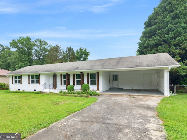 117 Thomas St, Griffin, GA 30224 - ranch-style house featuring asphalt driveway, covered porch, a front lawn, and a carport