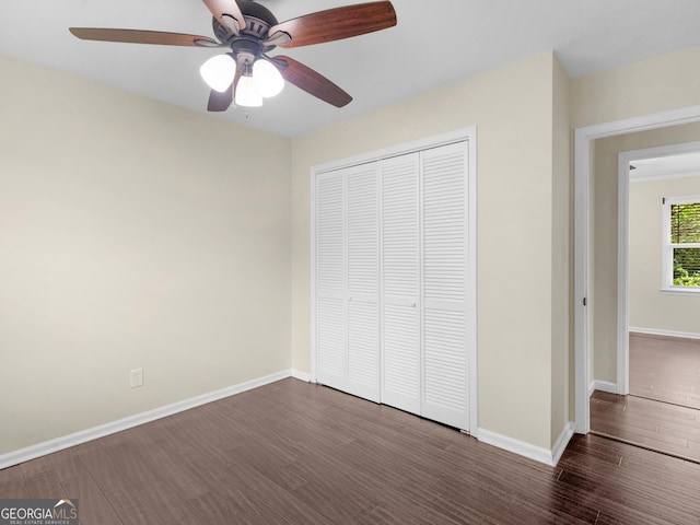 117 Thomas St, Griffin, GA 30224 - unfurnished bedroom featuring wood finished floors, a closet, baseboards, and a ceiling fan