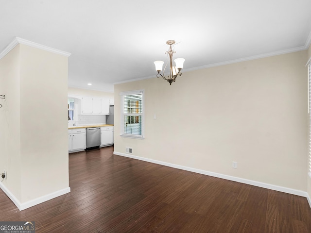 117 Thomas St, Griffin, GA 30224 - unfurnished dining area with dark wood-type flooring, a chandelier, baseboards, and crown molding