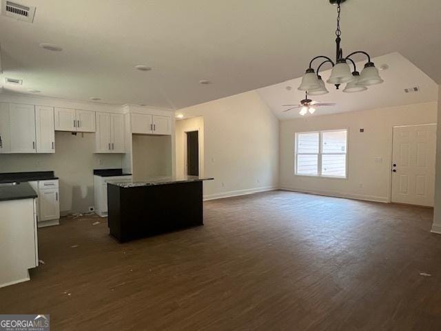 189 Warner Rd, Barnesville, GA 30204 - kitchen with a kitchen island, a chandelier, dark wood-type flooring, a ceiling fan, and lofted ceiling