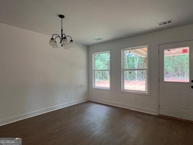 189 Warner Rd, Barnesville, GA 30204 - unfurnished dining area featuring a chandelier, dark wood-style flooring, and baseboards